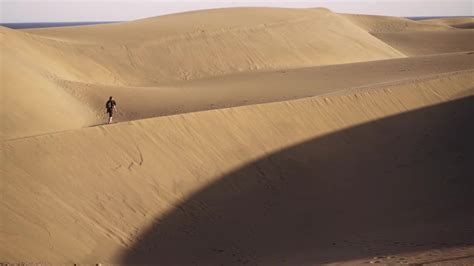 Man Walking Along Desert Sand Dune Stock Video Motion Array
