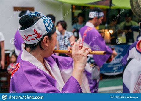 Woman Playing Japanese Traditional Music Instrument At Summer Festival
