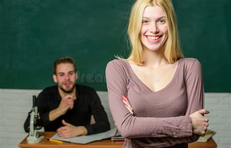 Happy Woman Standing Hands Crossed In Classroom With Teacher Female