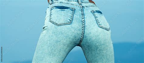 pretty women s ass in tight jeans on blue background fit female butt