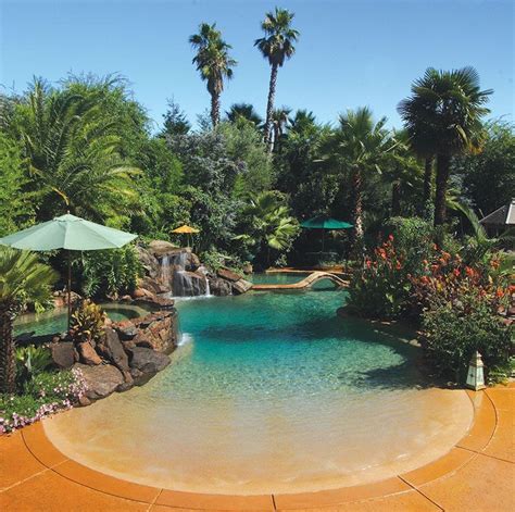 Residential Beach Entry Tropical Pool With Rock Waterfalls And Palm Trees By Advanced Pools