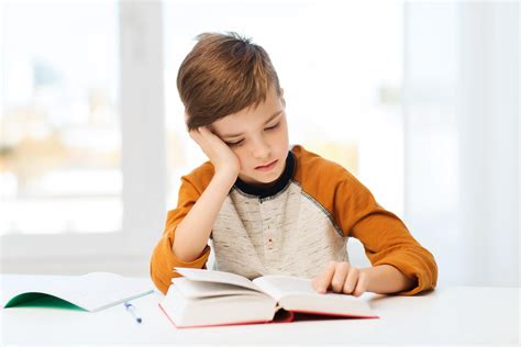 Student Boy Reading Book Or Textbook At Home Homeschooling With Dyslexia