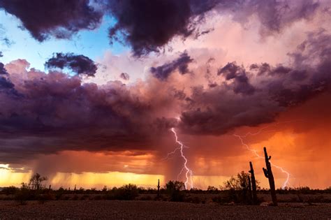Lightning Strikes From A Sunset Storm In The Arizona Desert Stock Photo