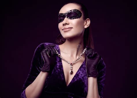 Elegant Brunette Woman In Beautiful Purple Dress Sequins Mask And Black Gloves Stock Image
