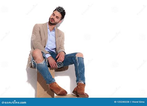 Smart Casual Man Sitting And Looking Down To Side Stock Photo Image