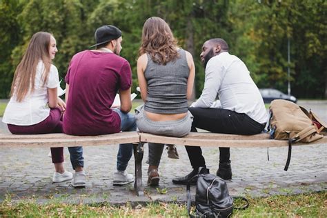 Group Of People Sitting On Bench Outside Photo Free Download