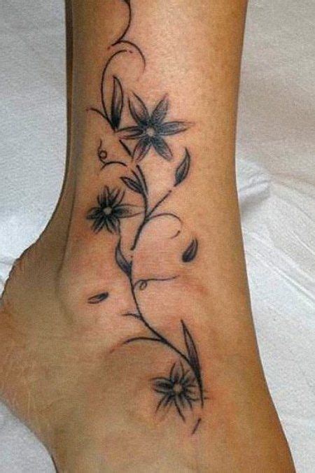 Vine tattoos in a simple vine pattern alone are a popular design. graceful black and grey tattoo having a single flower and ...