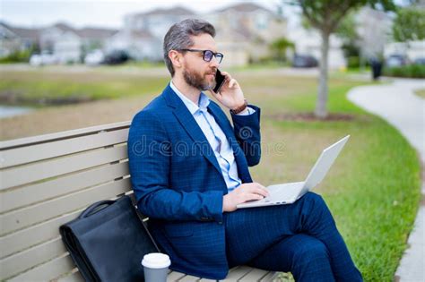 Business Talk Business Man Talk On Phone Sitting On A Bench In Park