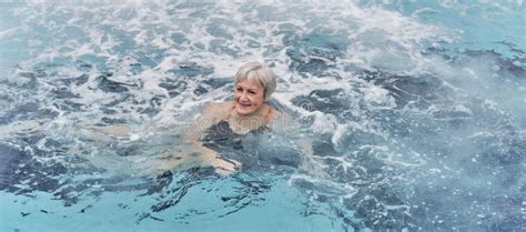 Mature Woman Swimming In Outdoor Thermal Pool With Hydromassage Stock