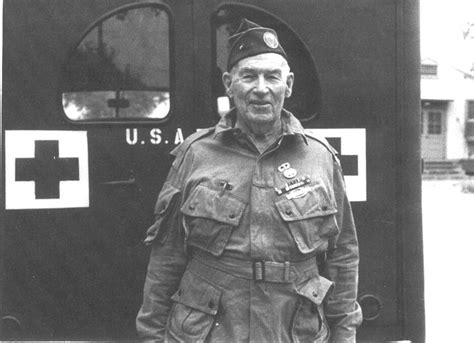 An Old Man In Uniform Standing Next To A Train