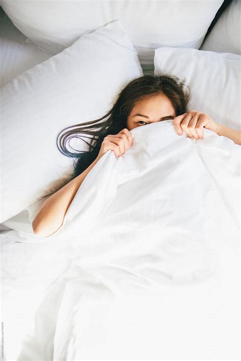 Young Woman Hiding Under Blanket In Bed By Andrey Pavlov