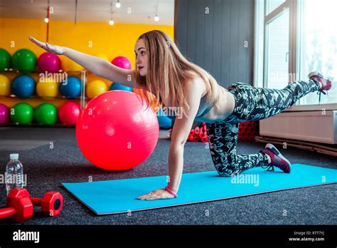 Shot Of Young Woman Stretching At The Gym Muscular Female Doing Exercisesto Stretch Her Body On