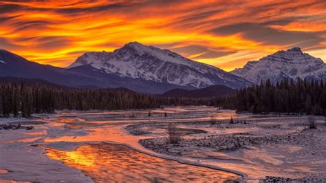 Sunset In Winter Mountains With Pine Trees Frozen River