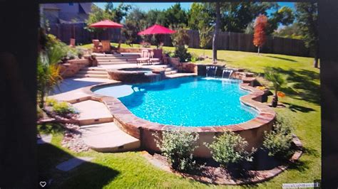Pool built into hill | Pool landscaping, Sloped backyard, Backyard pool