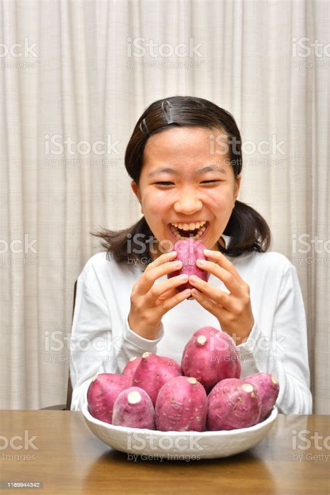 Japanese Girl Enjoys Having Sweet Potatoes Stock Photo Download Image