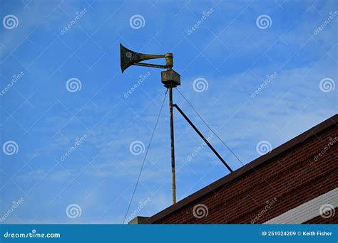 Tornado Siren Thunderbolt Mounted On Top Of Building With Guy Wires