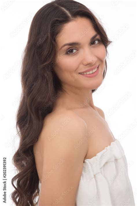attractive brunette with long curly hair standing half turn isolated on white background mid