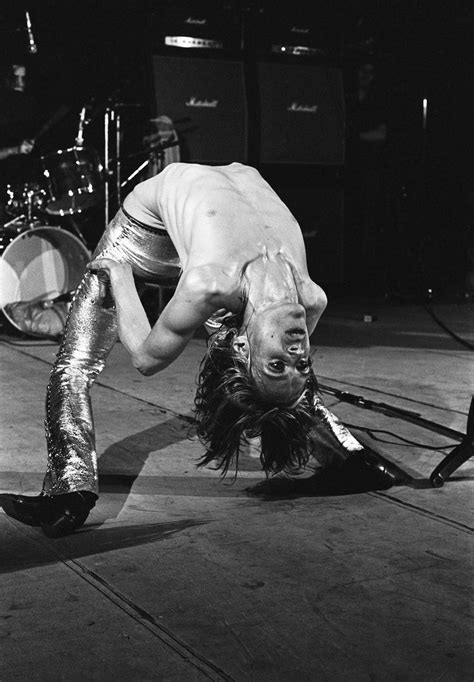 The Stooges Performing On Stage In Front Of Microphones And Drum Sticks With Their Legs Spread Out