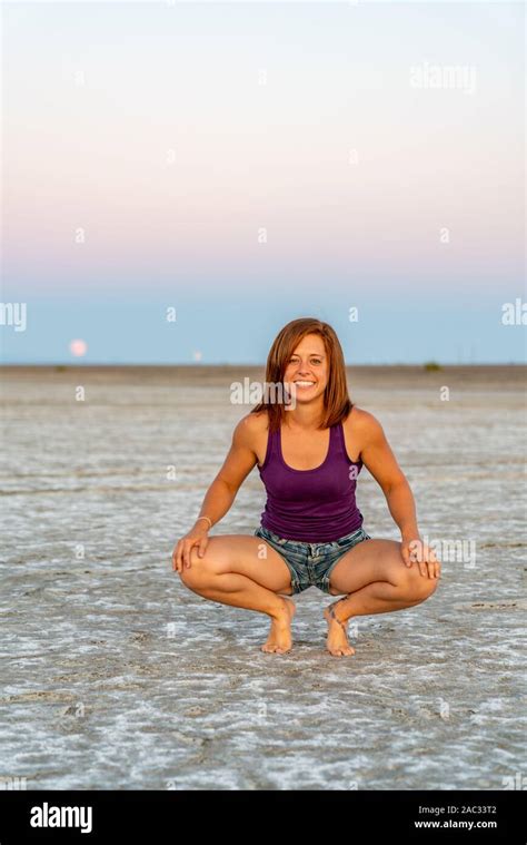Beautiful Woman Doing Handstands During Sunset In The Bonneville Salt
