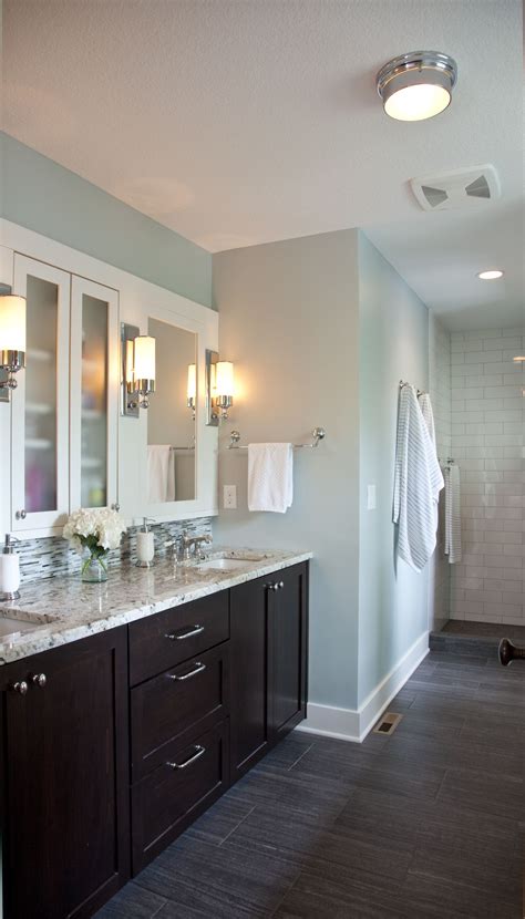 Vanity units are a practical and highly functional bathroom storage solution. like the floors, dark vanity, tiles; but with full mirror ...