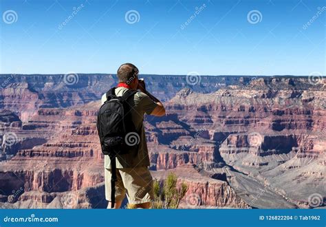 Mature Man Taking Photos Of The Grand Canyon During Summer Season Stock