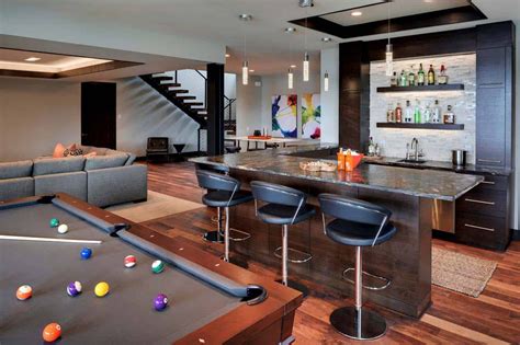 A Living Room With Pool Table Couches And Bar In The Middle Of It