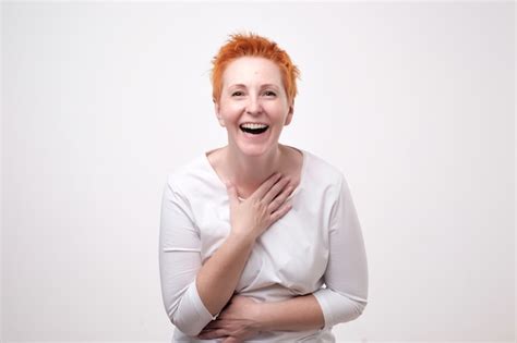 Premium Photo Mature Redhead Woman In A White Shirt