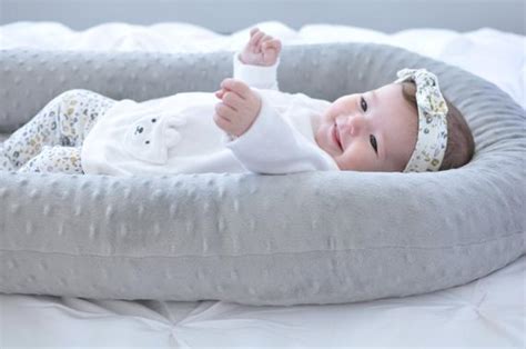 While babies are sleeping, you should always lay them on their back to help prevent sids. Cosleep Baby Bed white and gray cosleeping Baby Pillow