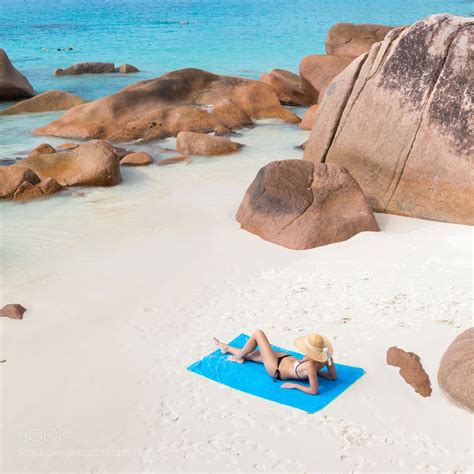 Woman Sunbathing At Anse Lazio Picture Perfect Beach On Praslin Island
