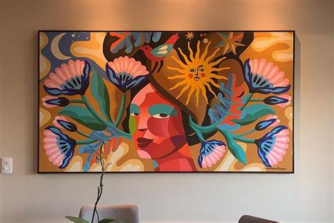 A Painting Hangs On The Wall Above A Dining Room Table