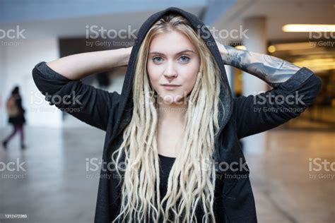 Young Tattooed And Pierced Woman With Blond Dreadlocks And Hoody Stock