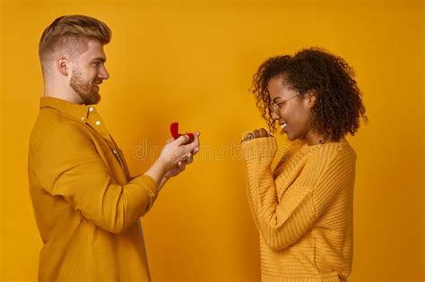 Handsome Man Making A Proposal To Happy Dark Skinned Woman With Ring