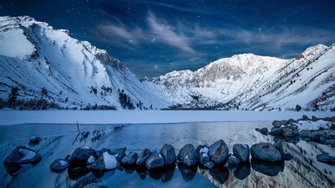Beautiful Snowy Mountains In Starry Blue Sky Background During