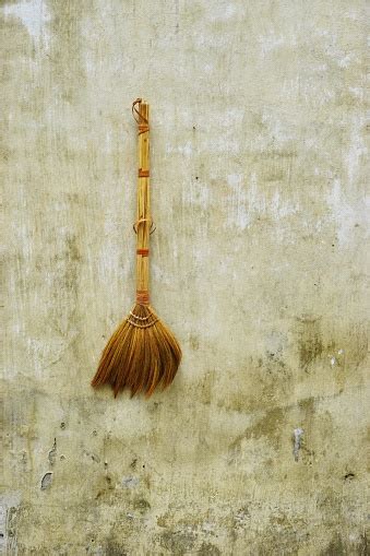 Vintage Handmade Broom Hanging On A Funky Stucco Wall In Rural Vietnam