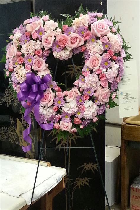A Funeral Heart Standing Spray Made With All Pink And Lavender Flowers