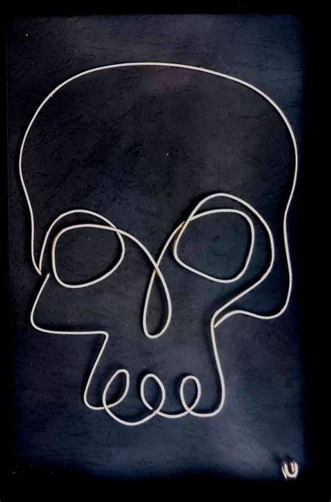 A Neon Sign With An Image Of A Skull In The Shape Of A Human Head