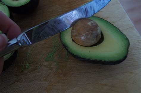 Aim your knife at the pit and whack into it, using enough force that the knife won't slip. Honest And Truly!: Tasty Tuesday - How To Cut An Avocado