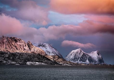 Snowcapped Mountain Range And Norwegian Sea During Blue Hour In