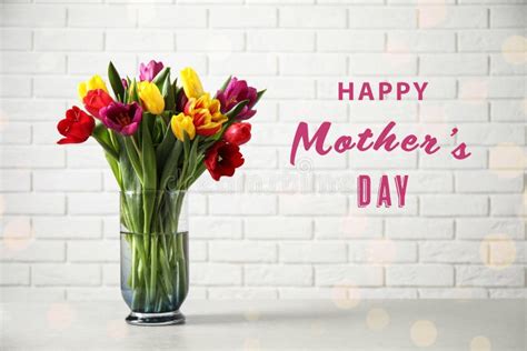 Vase With Beautiful Tulips And Phrase Happy Mother S Day On Table Stock