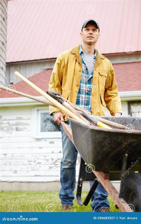 I Work Hard A Serious Man Standing Outside With His Wheelbarrow Stock Image Image Of Garden