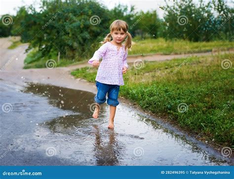 Girl Junps Barefoot In A Puddle Stock Image Image Of Playful Enjoyment