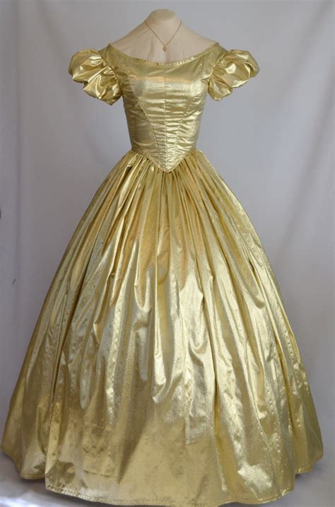 From the beaded floral details to the lamé fabric's liquid feel, this graceful gold dress exudes decadence. The Story of a Seamstress: Gold Lame Ballgown