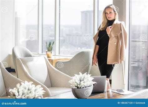 Stylish And Elegant Sophisticated Professional Woman In Business Attire Outfit Posing In