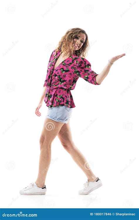 Side View Of Happy Young Woman Walking Turning Back And Sending Goodbye