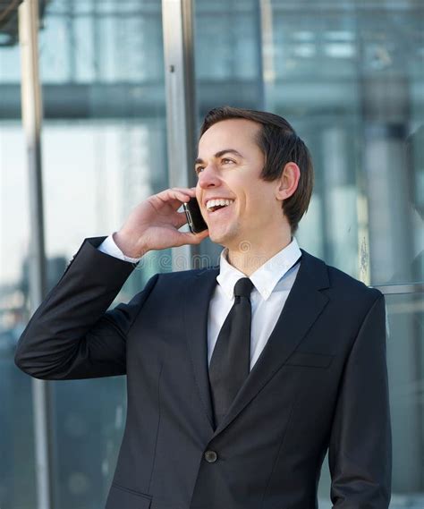 Portrait Of A Businessman Talking And Laughing On Mobile Phone Stock