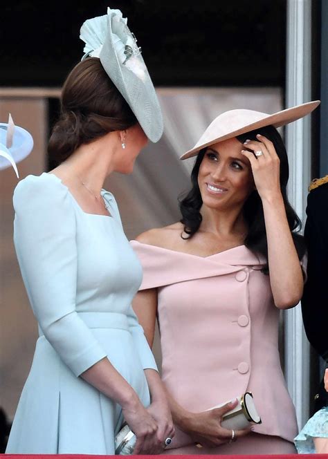 meghan markle and kate middleton curtsy to the queen