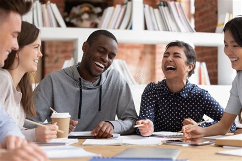 Smiling Multiracial Young People Have Fun Studying Together Stock Photo