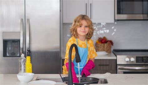 Premium Photo Dish Washing Concept Child Doing And Wiping Dishes In