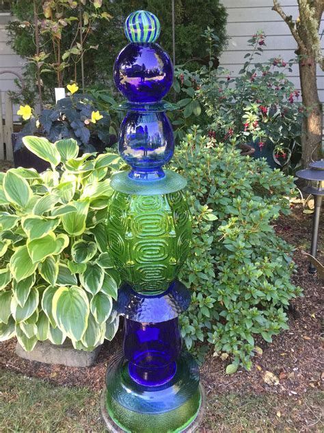 Three Large Totems On Display In Garden Art Sculptures Glassware Garden Art Glass Garden Art