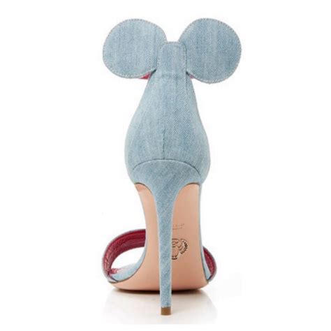 Black leather oscar tiye mickey sandals with tonal stitching throughout, red trim at backs, stiletto heels and buckle closures at ankles. Tacones Minnie Mouse by Oscar Tiye | Belleza